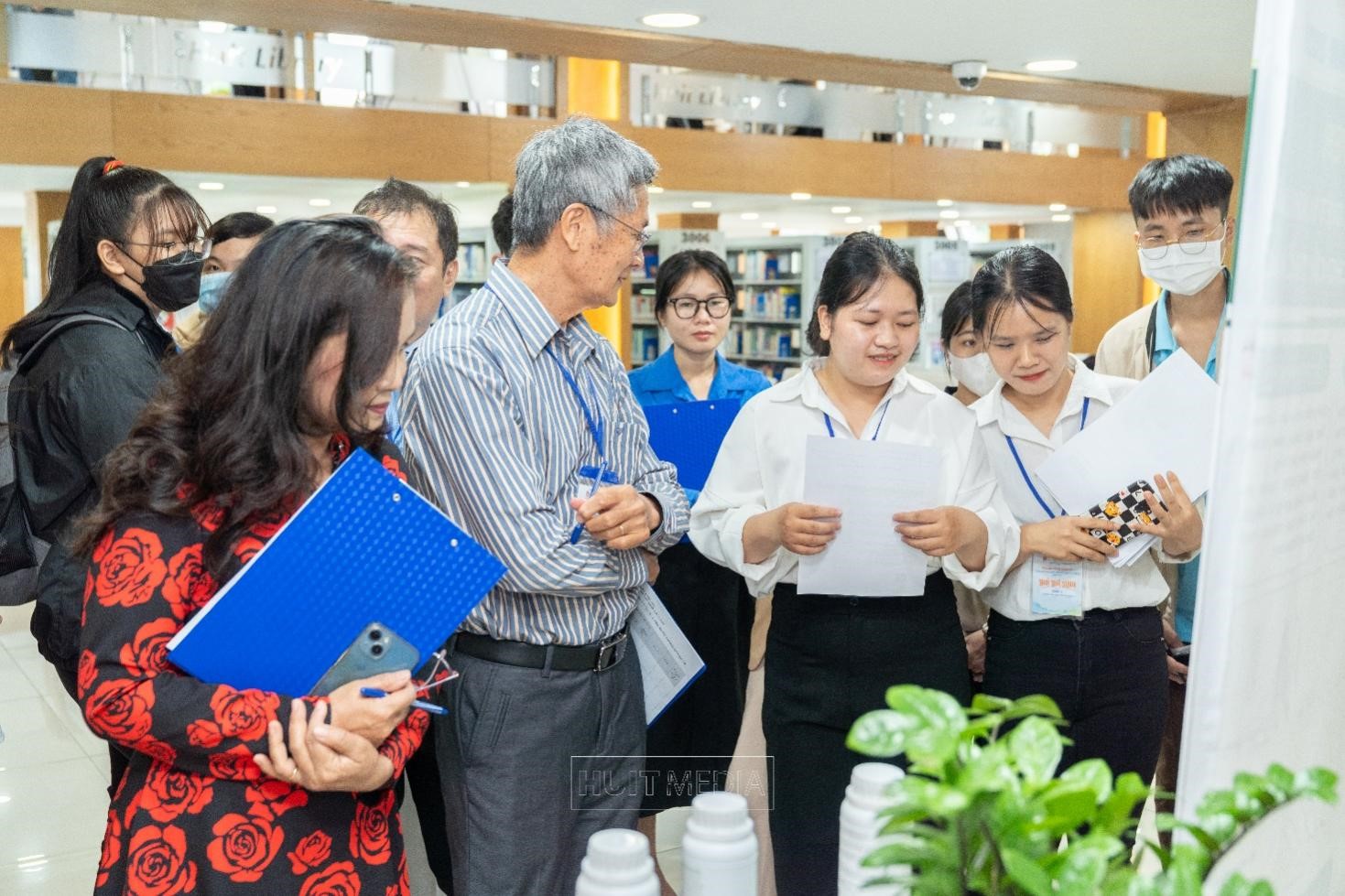 A group of people standing in a roomDescription automatically generated